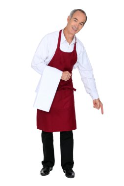 Wine waiter pointing down at copy space clipart