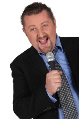 Chubby businessman singing karaoke clipart