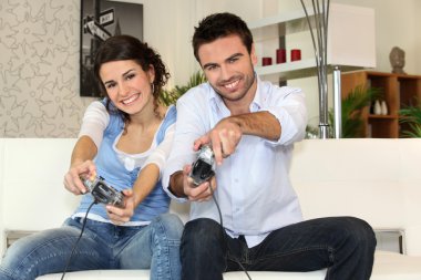 A couple having fun playing video games clipart
