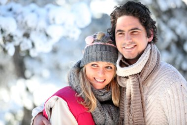 Portrait of happy couple at winter resort clipart