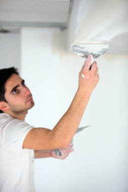 Man plastering a ceiling clipart