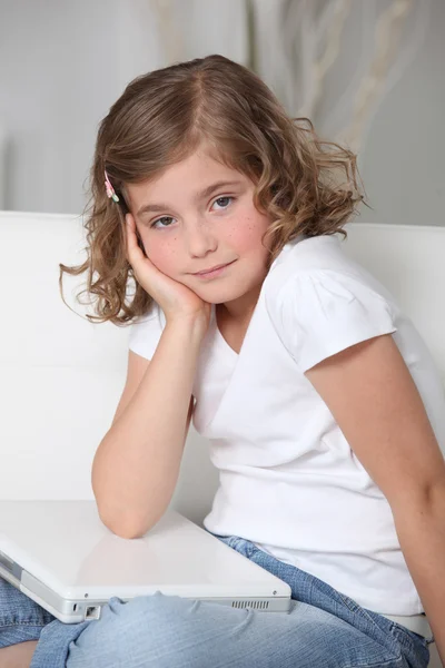 Pequena menina entediada sentou-se com laptop — Fotografia de Stock