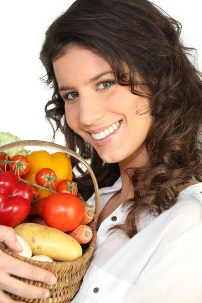 Brunette with basket of vegetables — Stock Photo, Image