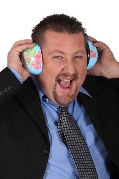 Businessman listening the sound of the world — Stock Photo, Image