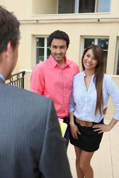 stock image Estate-agent with young couple