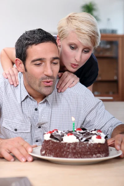 Couple blowing candle — Stock Photo, Image