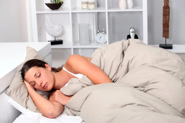 Woman asleep in bed — Stock Photo, Image