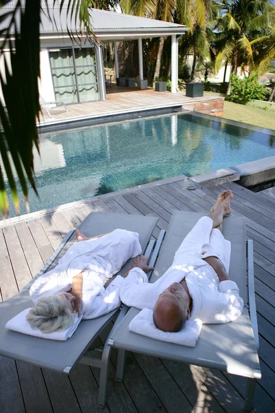 stock image Couple on loungers next to a private pool
