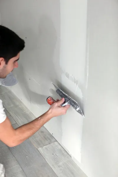 Young artisan plastering wall — Stock Photo, Image