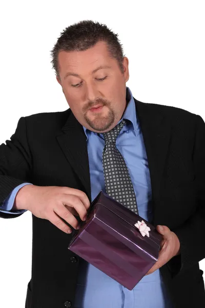 Man opening a present Stock Image