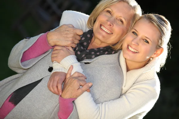 祖母和孙女拥抱在一起 免版税图库照片