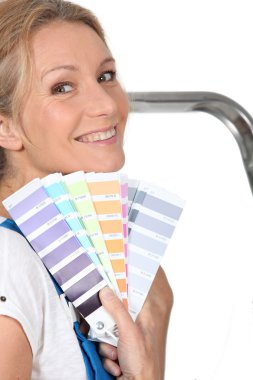 Woman choosing paint color clipart