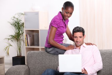 Couple in living room with computer