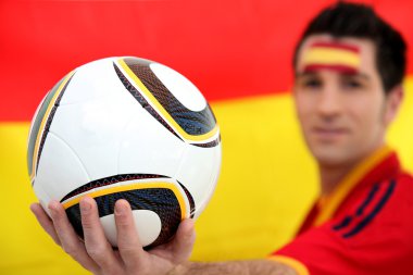 Football supporter holding soccer ball clipart