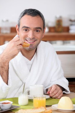 Man eating breakfast in your bathrobe clipart