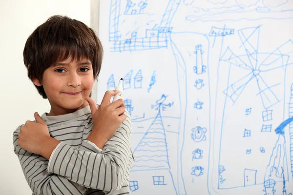 Child in front of blackboard drawings — Stock Photo, Image