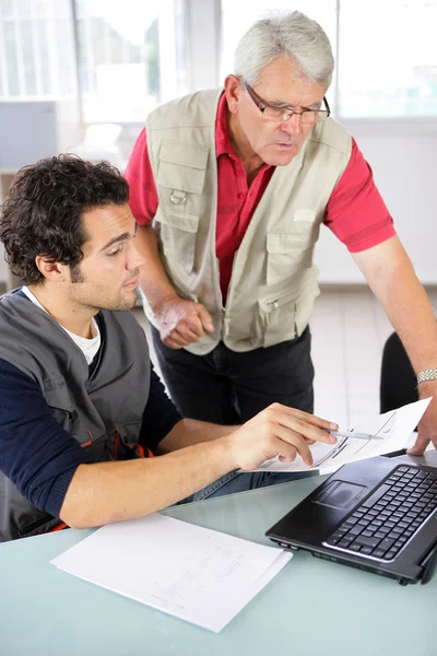 Worker going through some paperwork — Stockfoto