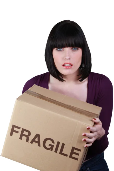 Woman carrying a heavy box — Stock Photo, Image