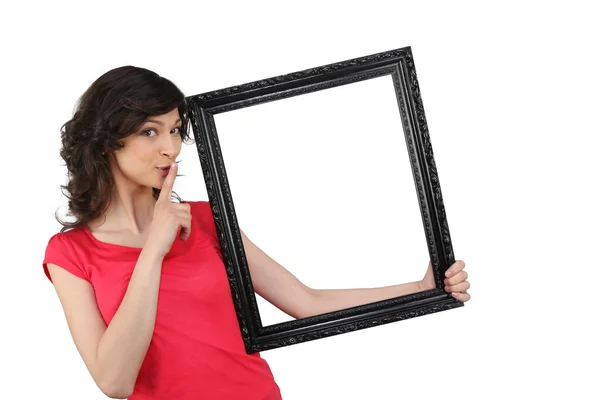 Woman holding a picture frame — Stock Photo, Image