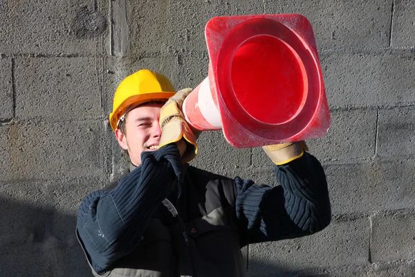 Man looking through construction beacon — Stock Photo, Image