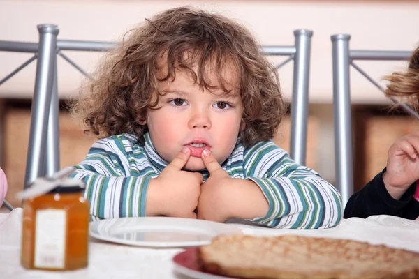 Criança olhando prato de panquecas — Fotografia de Stock