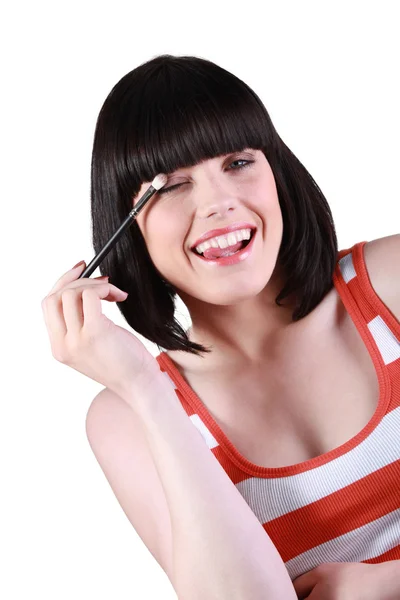 Chica feliz poniéndose algo de maquillaje — Foto de Stock