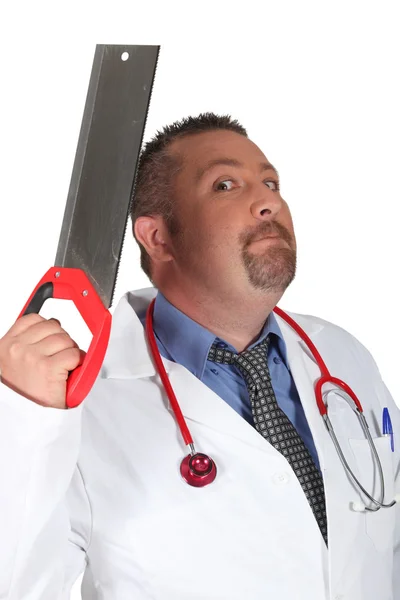 Scary surgeon holding saw — Stock Photo, Image