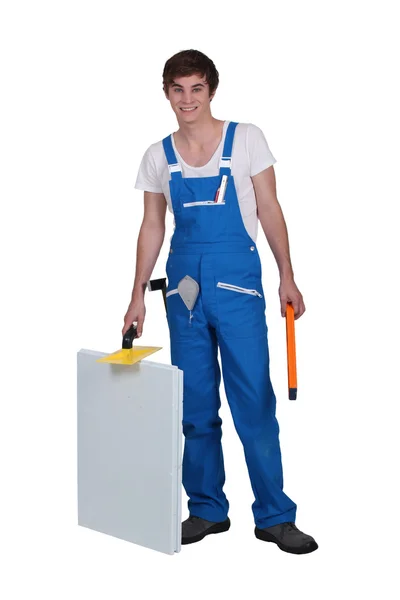 Studio shot of a young plasterer and equipment — Stock Photo, Image