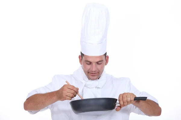 Chef stirring contents of saucepan — Stock Photo, Image