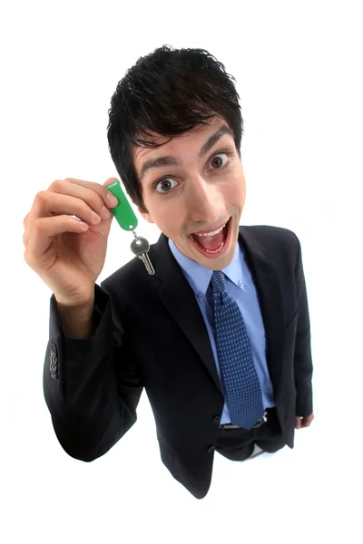 Un loco hombre de negocios entregando una llave . —  Fotos de Stock