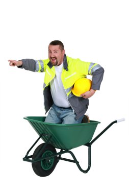 Craftsman sitting in a wheelbarrow clipart