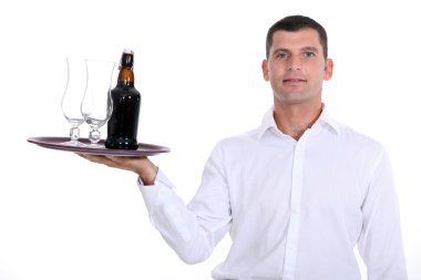 Waiter serving a bottle of beer clipart