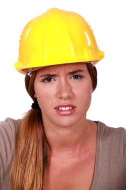 Concerned woman in a hardhat clipart