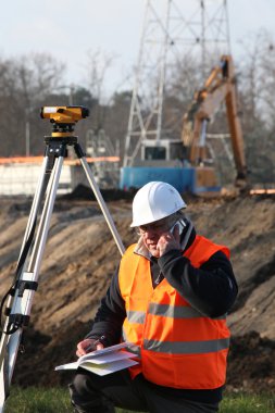 Surveyor at construction site clipart