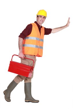 Tradesman pushing an invisible wall clipart