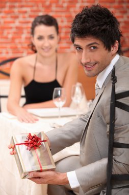 Man giving gift to woman clipart