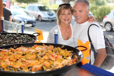 Couple in front of paella clipart