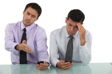 Businessmen receiving bad news via text message clipart