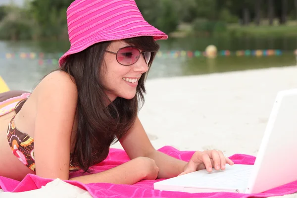 stock image Girl with pink hat and computer