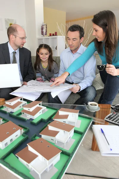Young family sitting in an architect's office — Stock Photo, Image