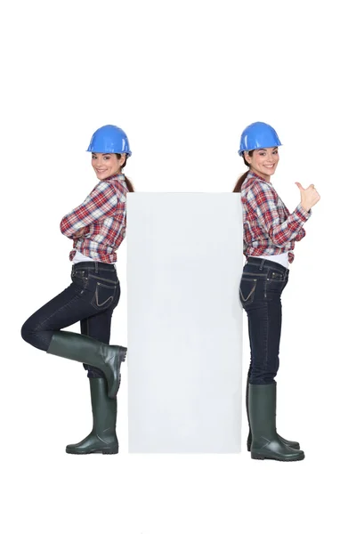 Mirror image of female builder — Stock Photo, Image