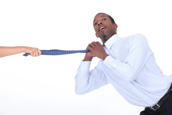Female hand pulling man's tie — Stock Photo, Image