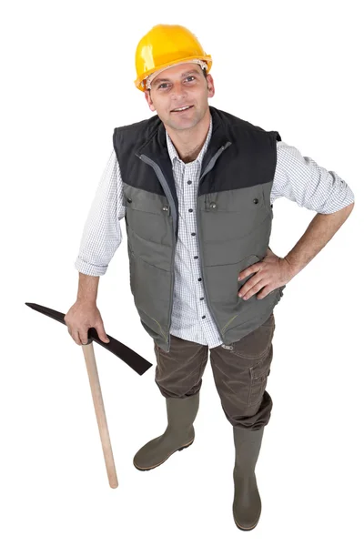 Muž stál pózuje s pick axe — Stock fotografie