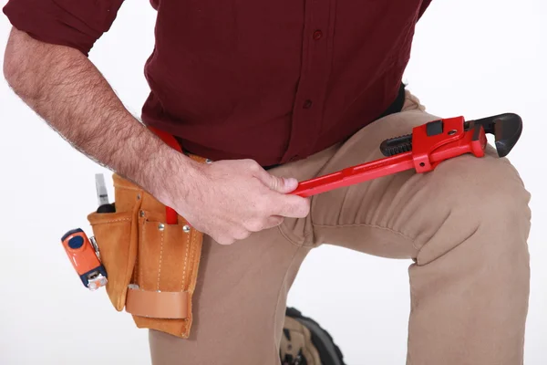 A cropped picture of a handyman with a wrench. — Stock Photo, Image