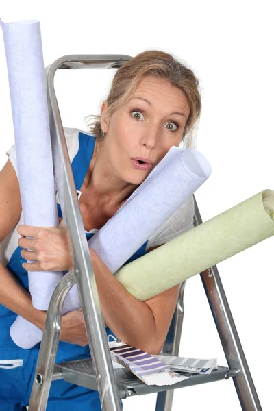 Woman with rolls of wallpaper — Stock Photo, Image