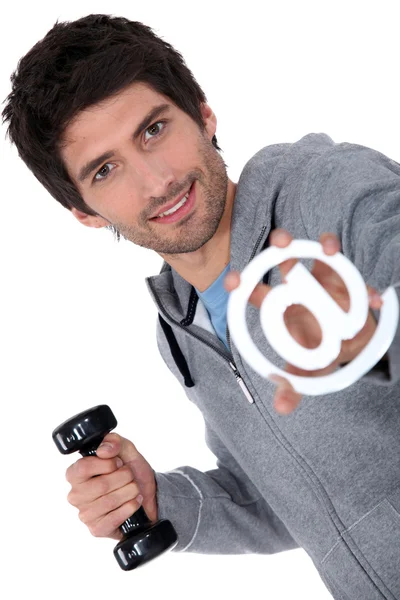 Man holding barbell and at sign — Stock Photo, Image