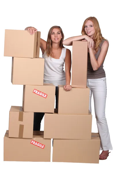Girls surrounded by boxes — Stock Photo, Image