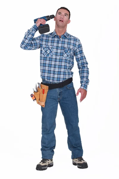 Man pressing power drill against temple — Stock Photo, Image