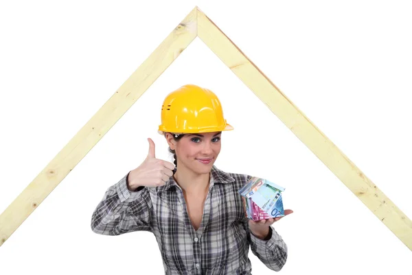 stock image Female carpenter with money