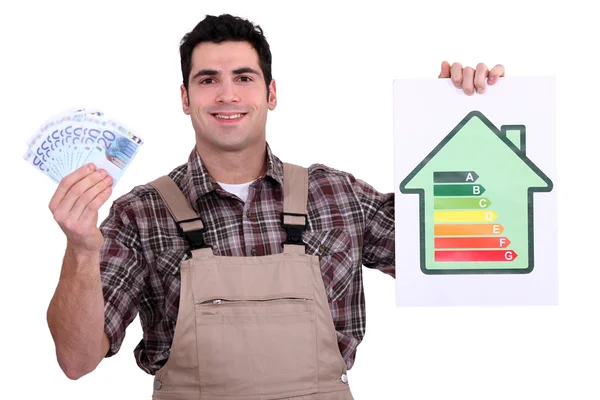 stock image Worker holding money and an energy efficiency rating chart